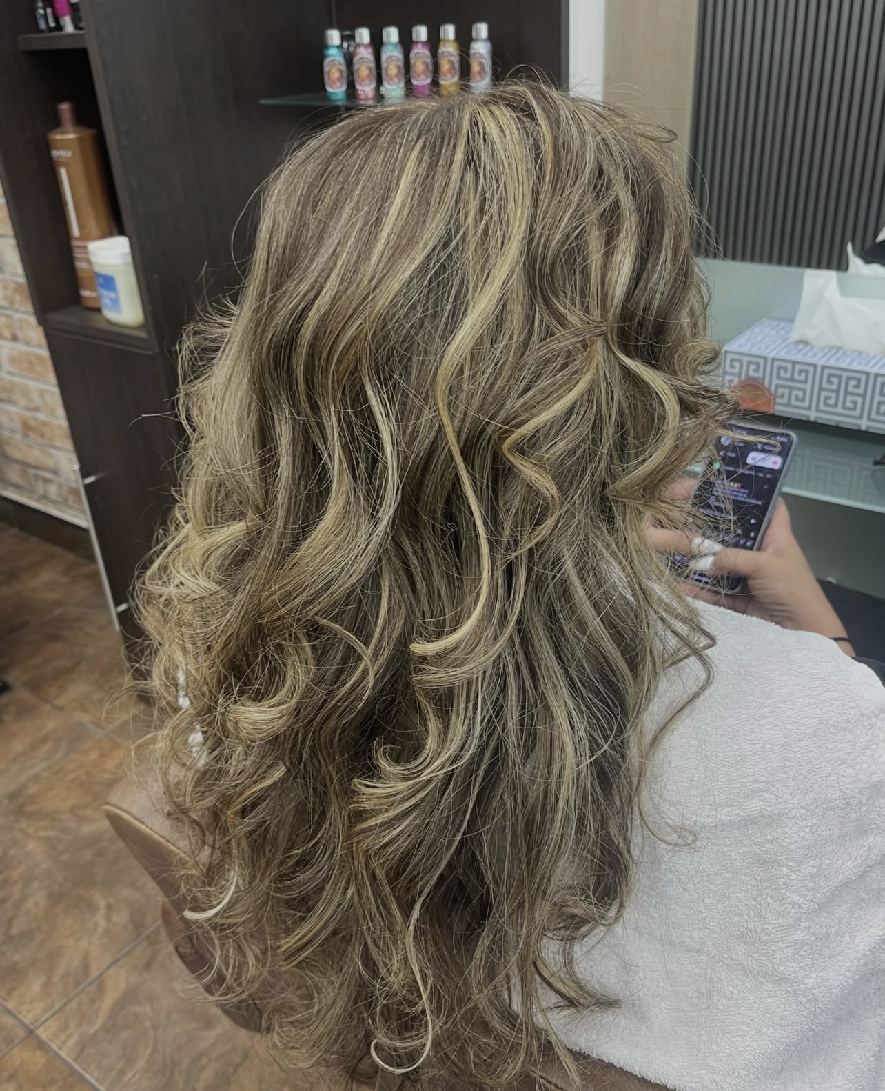 Long soft waves with natural-looking blonde highlights