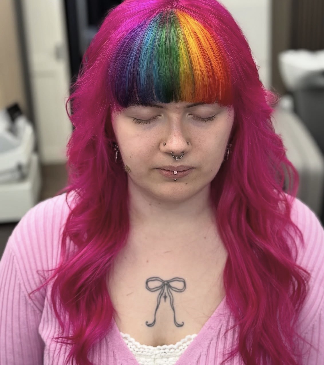 Bright pink hair with a rainbow-coloured fringe