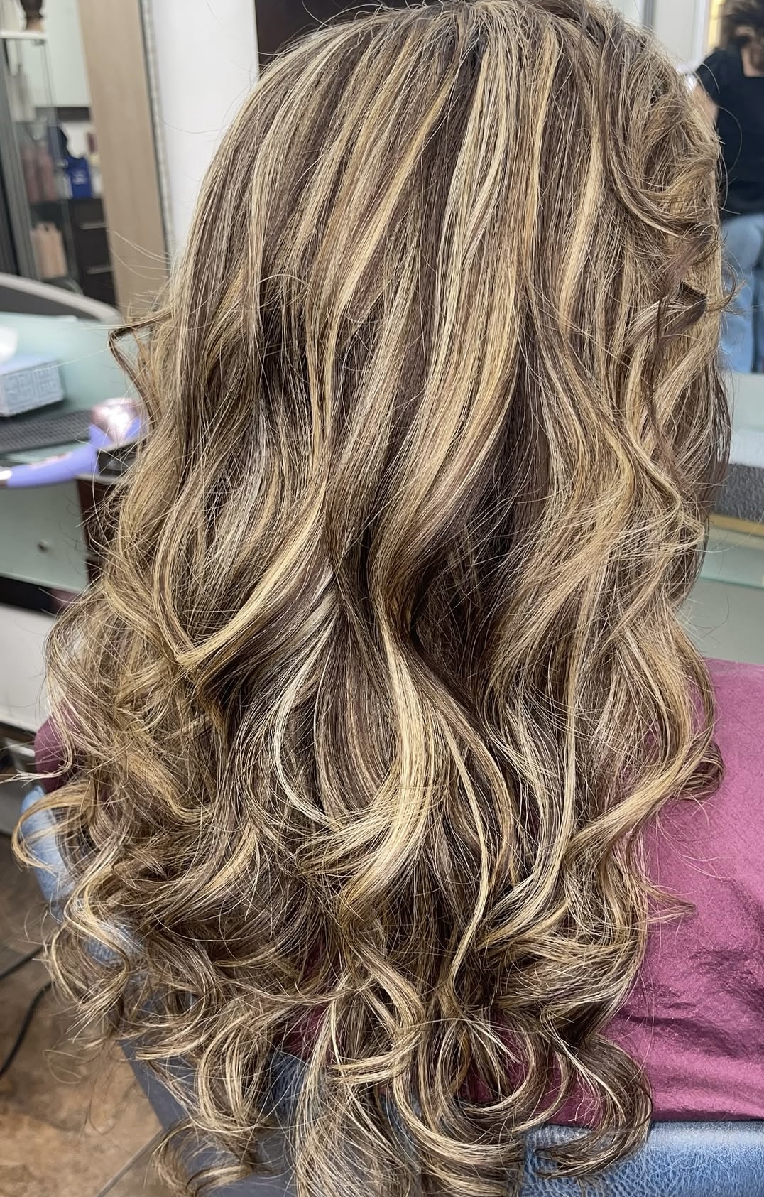 Long brunette waves with golden blonde highlights
