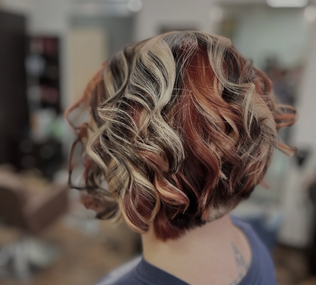 Curled bob with copper, blonde and dark dimensional colour